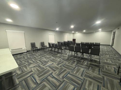 a conference room with chairs and a whiteboard at Quality Inn & Suites at Airport Blvd I-65 in Mobile