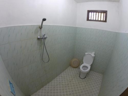 a bathroom with a shower and a toilet at Eka's Homestay in Ubud