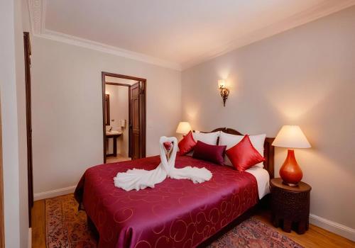 a hotel room with a bed with a towel on it at Abelia Riad - 2024 traveler's Choice Award in Marrakech