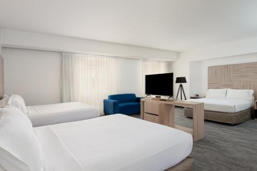 a hotel room with two beds and a television at Crowne Plaza Lima by IHG in Lima