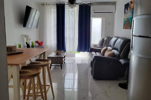 a living room with a couch and a table at Jamrock Place in Montego Bay