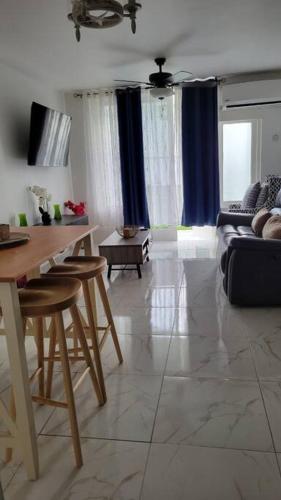 a living room with a table and a couch at Jamrock Place in Montego Bay