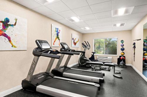 a gym with three tread machines in a room at Best Western Ontario Mills Mall in Ontario