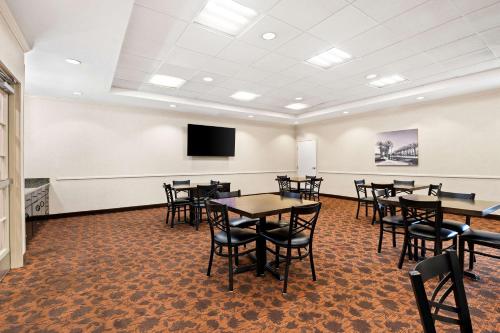 a conference room with tables and chairs and a tv at Best Western Ontario Mills Mall in Ontario