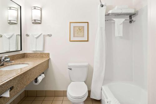 a bathroom with a toilet and a sink at Best Western Ontario Mills Mall in Ontario