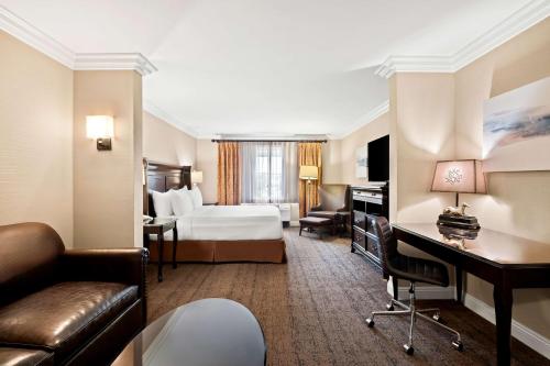 a hotel room with a bed and a desk at Best Western Ontario Mills Mall in Ontario