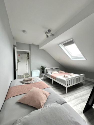a attic bedroom with two beds and a skylight at DVM escape Flat 3 in Bristol