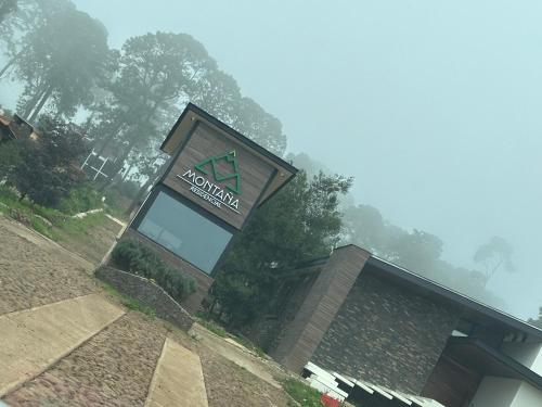 a building with a sign on top of it at Cabaña DAGO in Mazamitla