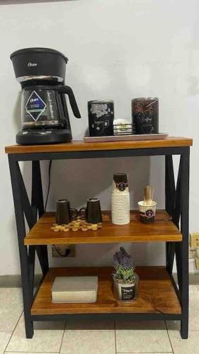 a shelf with a coffee maker on top of it at Apartamento en alquiler en la guaira con piscina in La Guaira