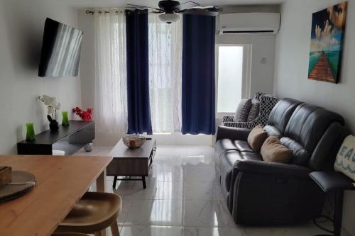 a living room with a couch and a table at Jamrock Place in Montego Bay