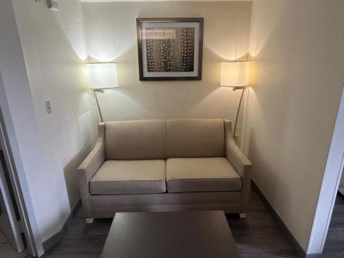 a waiting room with a couch and two lamps at Red Roof PLUS Fort Myers in Fort Myers