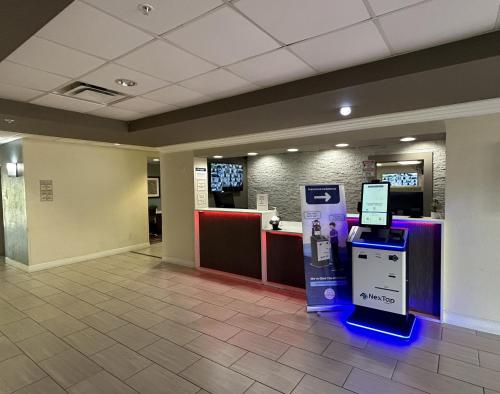 a lobby with a atm machine in a building at Red Roof PLUS Fort Myers in Fort Myers