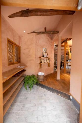 a large room with a stone wall and a room with at mokumoku海sakanoshita in Kamakura