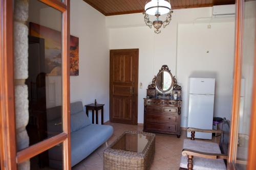 a living room with a blue couch and a mirror at SeaFront Stone Suites in Vonitsa