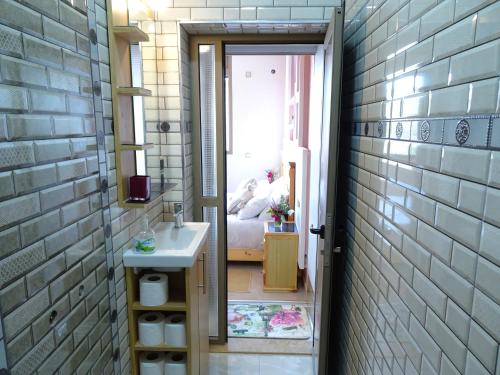 a bathroom with a sink and a bed in a room at Paradise House Apartment in Tamraght in Tamraght Ouzdar