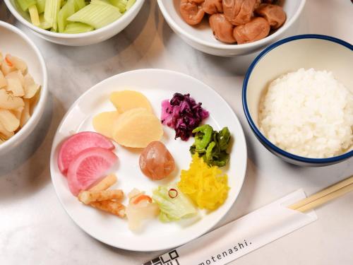 a plate of food with vegetables and rice on a table at JR East Hotel Mets Premier Yokohama Sakuragicho in Yokohama