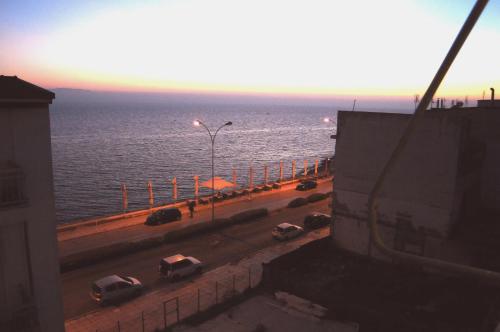 a view of a street with cars parked on a road near the ocean at Hotel Alkyon in Alexandroupoli