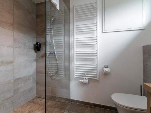 a shower with a glass door in a bathroom at Apart33 Top 2-1 in Haus im Ennstal