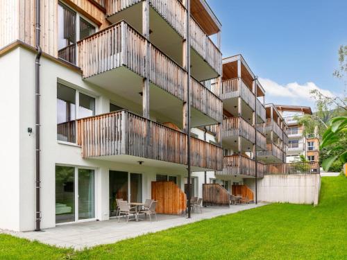 an apartment building with balconies and a lawn at Apart33 Top 2-1 in Haus im Ennstal