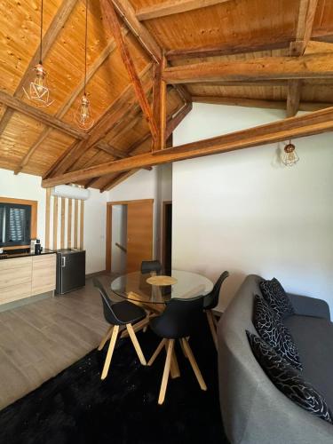 a living room with a couch and a table and chairs at R&F Dreams in Mondim de Basto