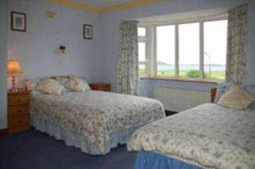 Säng eller sängar i ett rum på Seashore Lodge Guesthouse