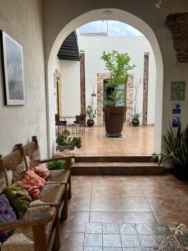 a living room with two couches and a large window at Hotel Boutique Cantera in Querétaro