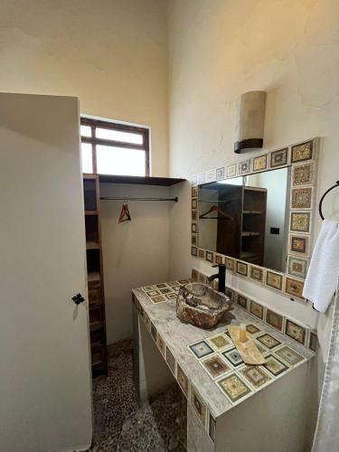 a kitchen with a counter and a sink in a room at Hotel Boutique Cantera in Querétaro