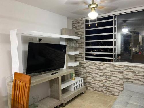 a living room with a flat screen tv on a wall at 1 Apartamento en Bucaramanga Santander in Bucaramanga
