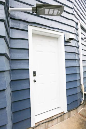 a white door on the side of a house at Fisherman Wharf Individual Artistic Studio in Richmond