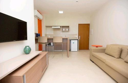 a living room with a couch and a flat screen tv at Alta Vista Thermas Resort in Caldas Novas