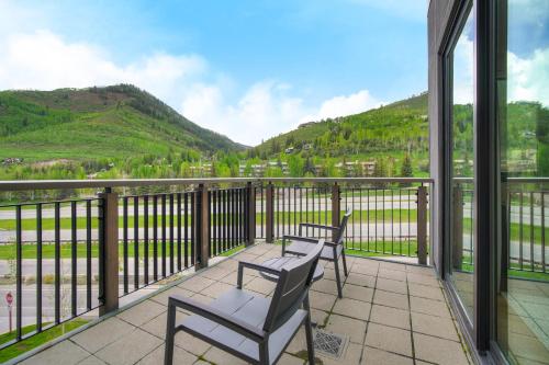 two chairs and a table on a balcony with mountains at The Arrabelle at Vail Square, a RockResort in Vail