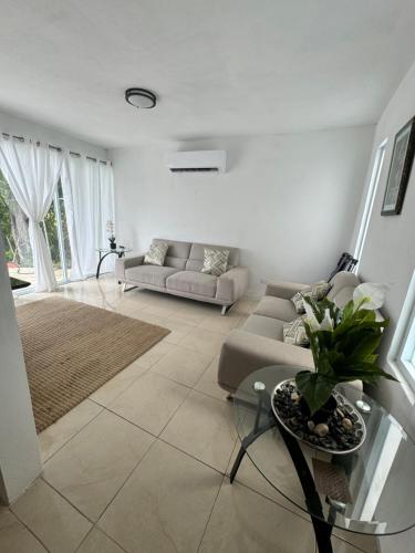 a living room with a couch and a table at Hacienda Bella Vista in Limones