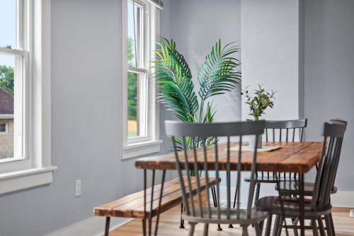 a dining room table with chairs and a plant at Slick&Spacious 2 Bdr Apt Natrona Hts in Natrona Heights