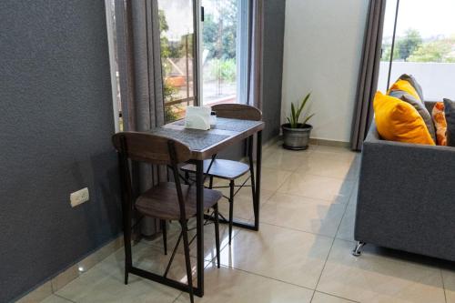 a small table with two stools in a room at Apartamentos Villa Antonela in La Ceiba