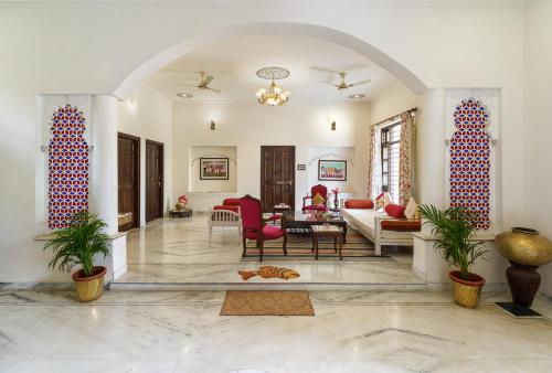 a living room with a couch and a table at Yellow Bells in Udaipur