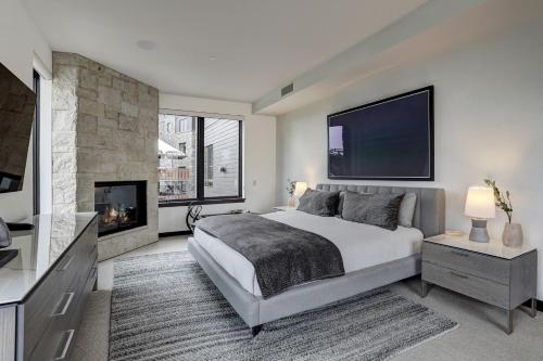 a bedroom with a large bed and a fireplace at The Arrabelle at Vail Square, a RockResort in Vail
