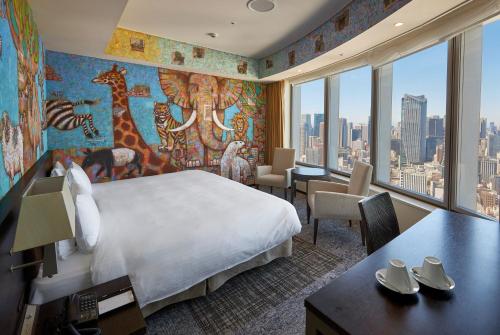 a hotel room with a large bed and a large window at Park Hotel Tokyo in Tokyo