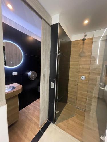 a bathroom with a shower and a sink at Hotel Plaza Norte Cali in Cali