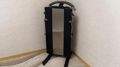 a black suitcase is leaning against a wall at JR East Hotel Mets Premier Yokohama Sakuragicho in Yokohama