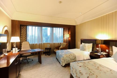 Letto o letti in una camera di Wuhan Jin Jiang International Hotel