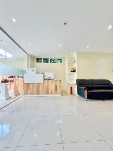 a living room with a couch and a counter at ABC HA Hotel Bangkok in Bangkok
