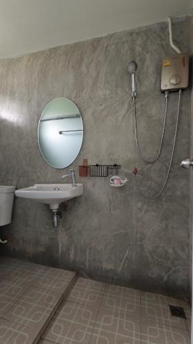 a bathroom with a sink and a shower with a mirror at โซพราว เขาค้อ So Proud Khaokho in Khao Kho