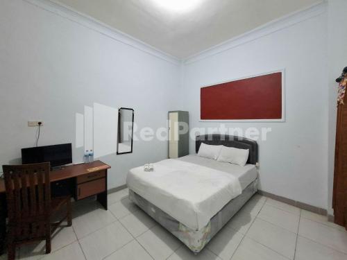 Ένα ή περισσότερα κρεβάτια σε δωμάτιο στο Assalaam Homestay Syariah RedPartner