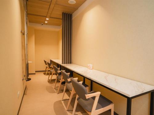 a row of chairs and a long table in a room at Royal Rose Hotel Zhongshan in Taipei