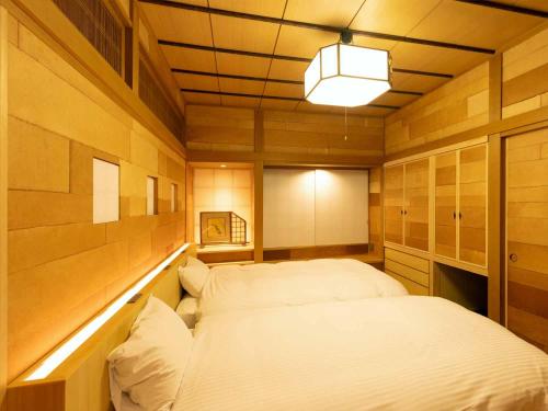 a small room with a bed in it at Ryoso Yufuin Yamadaya in Yufuin
