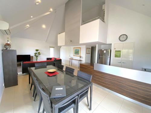 a kitchen and living room with a table and chairs at Osprey Holiday Village Unit 104 in Exmouth