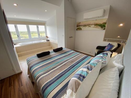 a bedroom with a large bed and a window at Osprey Holiday Village Unit 104 in Exmouth