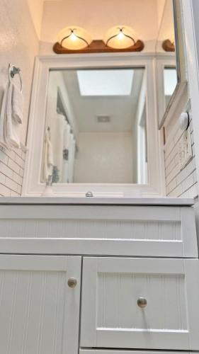 a white bathroom with a sink and a mirror at Vacation Family Home - Close to Disney in Kissimmee