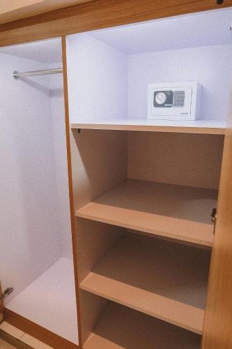 a kitchen cupboard with a microwave on top of it at Bali Wirasana Inn in Sanur