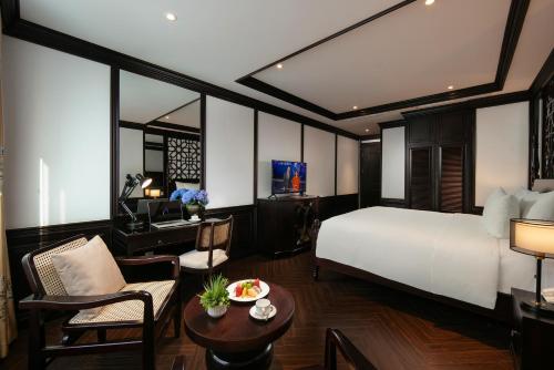 a hotel room with a bed and a desk at MAY DE VILLE Crown Hotel in Hanoi